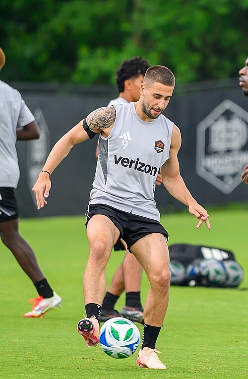 Football player practicing dribbling drills during a professional soccer training session. What Muscles Does a Soccer Ball Sculpt?