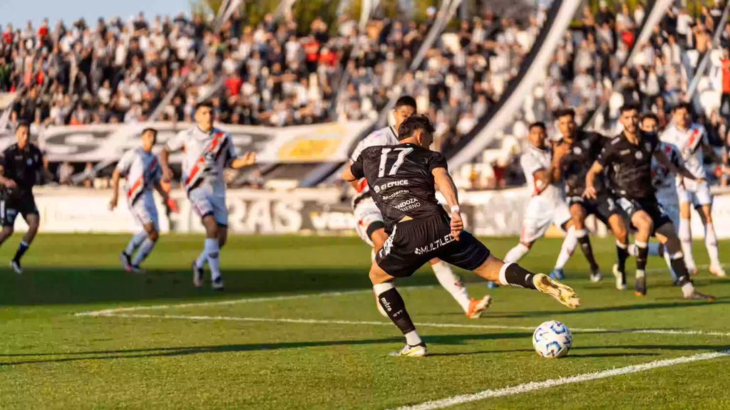 How Do Soccer Teams Use GPS Tracking. Soccer player striking the ball during a professional match.